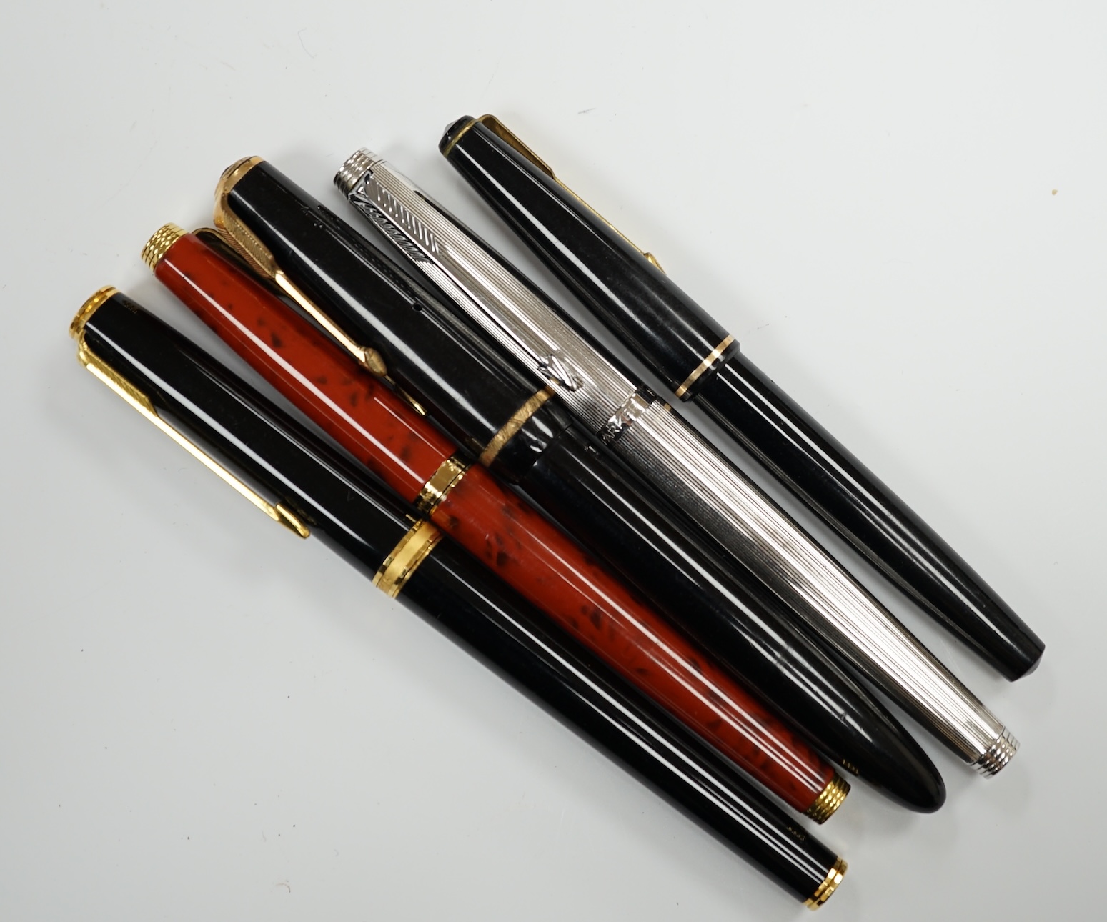 A Parker white metal fountain pen and four other Parker fountain pens, the vendor being an ex-Parker Pen employee